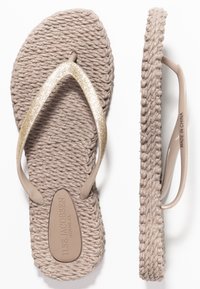 Beige woven flip-flop with a textured sole, featuring a glittery gold strap and a molded footbed with embossed branding.