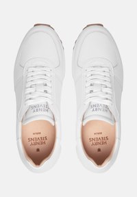 Sneaker bianche con tomaia in pelle liscia, punta rotonda e chiusura con lacci. Le soletta interne di color beige chiaro presentano il testo del logo. Suola in gomma con grip testurizzato.
