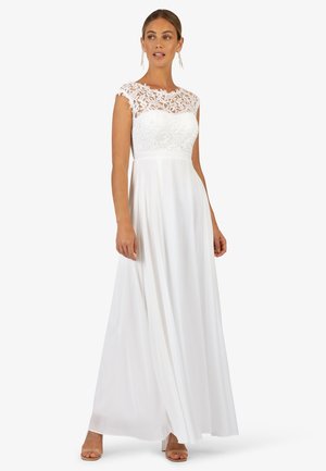 Witte maxi-jurk met een kanten bodice en korte mouwen, een soepel vallende rok en een getailleerde taille. Textuur bloemenkant voegt detail toe.