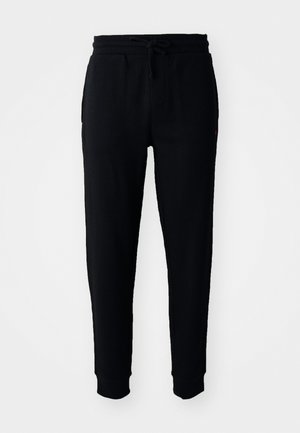 Schwarze Jogginghose aus einem strukturierten Stoff, mit elastischem Bund und Kordelzug, seitlichen Taschen und schmal zulaufenden Bündchen.