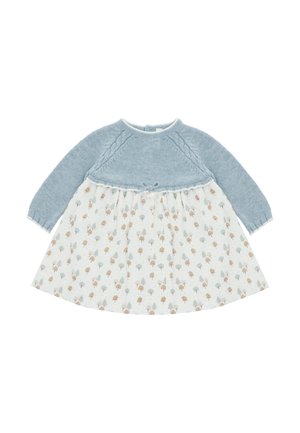 Vestido para bebé de manga larga con parte superior de punto azul y falda blanca decorada con pequeños patrones de árboles marrones y grises.