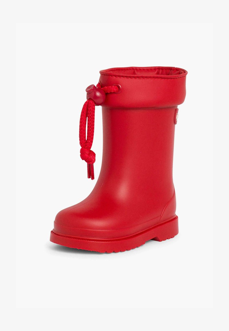Botte de pluie en caoutchouc rouge avec un bout arrondi, semelle texturée et cordon ajustable en haut. Surface lisse et tige haute pour le style et la fonctionnalité.