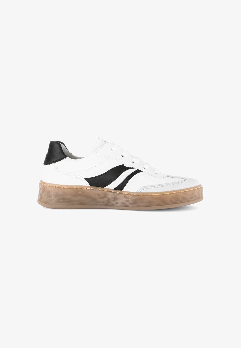 White low-top sneaker with black wave accents, black heel tab, white laces, and a textured light brown rubber sole.