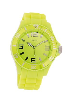 Bright yellow silicone watch with a round face, bold black hour markers, silver hands, and a textured strap. Features a mineral glass cover.