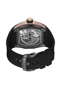 Črna ura z silikonskim paščkom, prozornim zadnjim delom ohišja, poudarki iz nerjavečega jekla ter zgornjim delom v rožnato zlati barvi, z razkritimi zobniki in zaponko iz nerjavečega jekla.