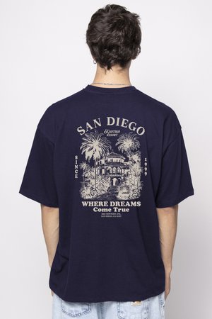 Navy blue cotton t-shirt featuring a graphic print of a house surrounded by palm trees, with text "SAN DIEGO" and "WHERE DREAMS Come True."