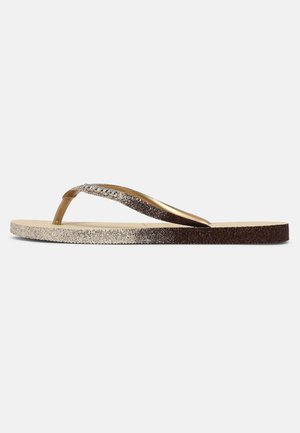 Chanclas con un diseño ombre de purpurina, que presentan tiras en degradado de marrón a plateado y una suela texturizada. Acabado brillante en las tiras.