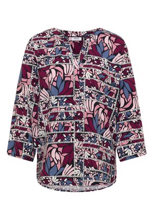 Blouse à manches longues avec col en V, présentant un motif floral abstrait multicolore dans des tons de rose, violet et bleu.