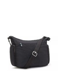 Black fabric shoulder bag with a structured shape, featuring a wide adjustable strap, front zipper pocket, and side zip compartments.