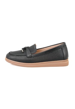 Black perforated leather slip-on shoes with a bow accent, featuring a brown rubber sole and a smooth texture.