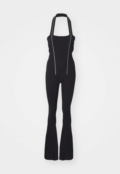 Black jumpsuit featuring a square neckline, adjustable straps, and two front zippers; fitted silhouette with flared legs and smooth texture.