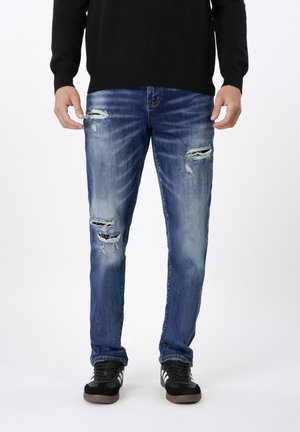 Pieguloša piegriezuma džinsi - blue denim