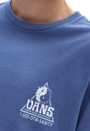 Blue cotton t-shirt featuring a white graphic print with a yin-yang symbol, triangle design, and text "VANS CLEAR MIND MEDITATION."