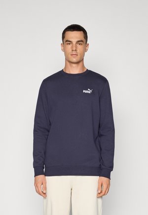 Navy blue sweatshirt in a solid color, crew neck design, soft texture, featuring a white Puma logo on the left chest. Long sleeves.