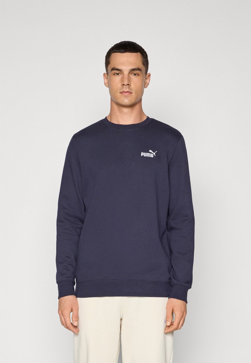 Navy blue sweatshirt in a solid color, crew neck design, soft texture, featuring a white Puma logo on the left chest. Long sleeves.