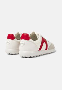 Sneakers featuring a mix of white leather, red leather accents, and grey suede, with a textured rubber sole and round laces.