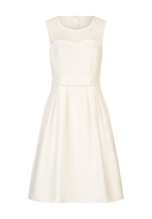 White sleeveless dress with a sweetheart neckline, featuring a sheer panel and a pleated skirt. Includes a bow accent at the waist.