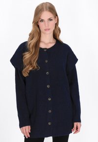 Granatowy, oversize'owy sweter z dzianiny z krótkimi rękawami, sześcioma guzikami z przodu i teksturowanym wykończeniem.