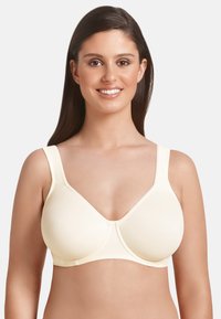 Light yellow seamless bra with wide straps, smooth cups, and V-neck design. Features minimal stitching and a soft texture.