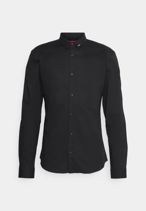 Black long-sleeve shirt, cotton material, button-up front, classic collar, and black buttons. Features a small brand tag on the collar.