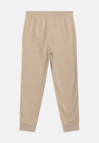 Champion ICONS CUFF PANTS CONTRAST LOGO UNISEX - Treniņtērpa apakšdaļas - beige