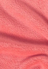 Coral pink fabric with a soft, textured fleece surface; features a smooth, plush appearance and gentle wave patterns in the material.