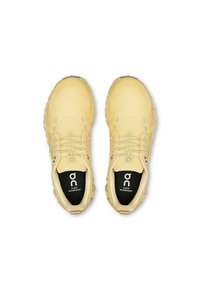 Yellow waterproof running shoes with a textured upper, lace closures, reflective accents, and cushioned insoles showcasing the brand logo.