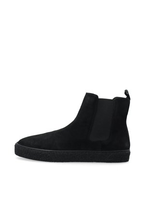 Botines de ante negro con paneles elásticos en los laterales y una suela de goma negra texturizada; diseño estilizado con una lengüeta en la parte posterior.