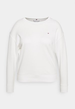 Sudadera blanca con cuello redondo, puños y dobladillo acanalados, con un pequeño logotipo multicolor en el pecho. Tejido suave y texturizado.