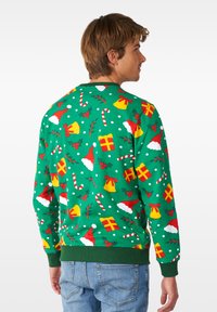 Felpa verde con motivi a tema natalizio: cappelli di Babbo Natale, bastoncini di zucchero, regali e campane, con pois bianchi e orlo a coste.