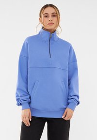 Lichtblauwe sweatshirts met een half-rits kraag, voorzakken, geribbelde boorden en een relaxte pasvorm. Zachte katoenmix.