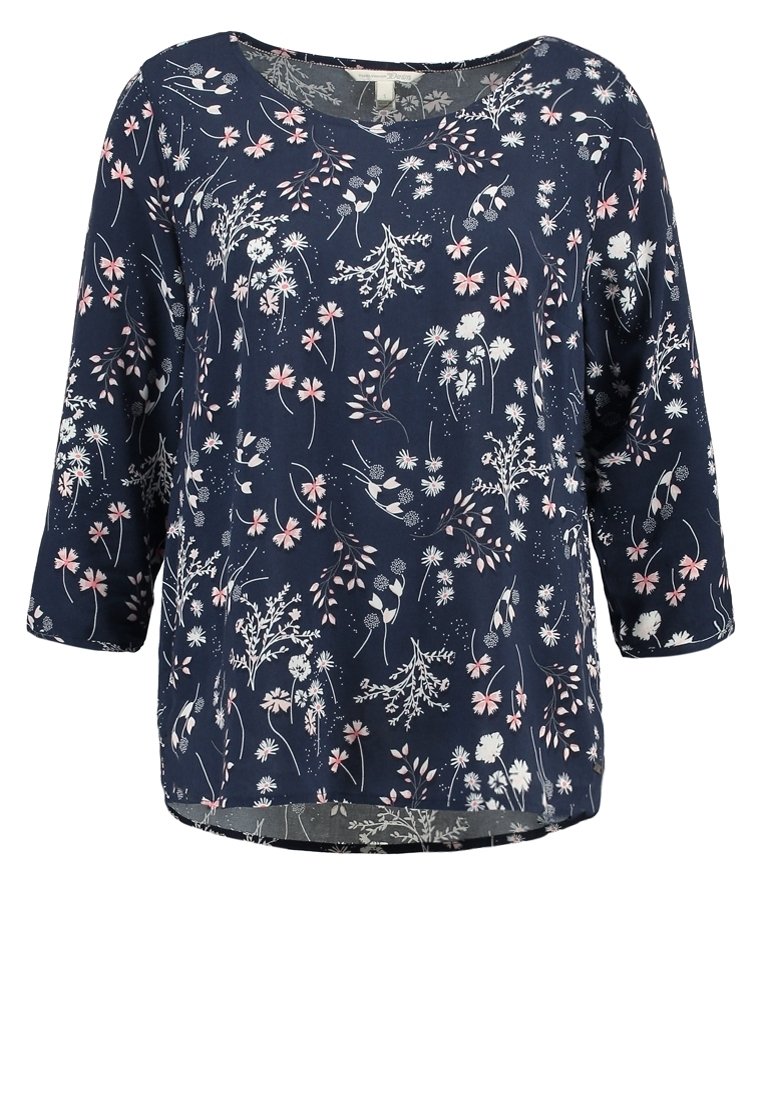Blouse bleu marine à manches longues avec un col rond, présentant un motif de petites fleurs blanches et roses.