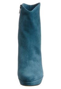 Teal suede ankle boot with a rounded toe, high platform, and zip closure on the side. Smooth texture and minimalist design.