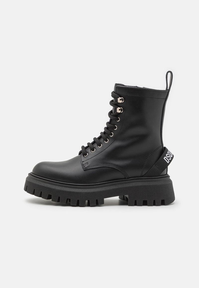 Botte de combat en cuir noir avec semelle épaisse à crampons, bout rond, laçage sur le devant, œillets métalliques et languette arrière à logo.