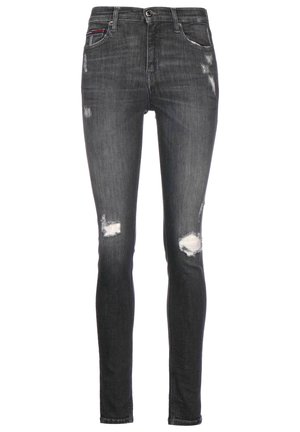 Jean skinny noir avec des patchs délavés et usés sur les cuisses et les genoux, cinq poches, et fermeture par bouton à la taille.