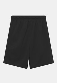 Jednoduché černé šortky s elastickým pasem, rovného střihu a délky do poloviny stehna, položené na bílé ploše.