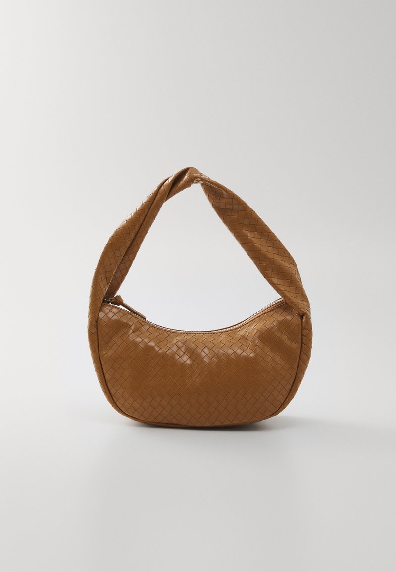 Woven leather handbag in tan, oval shape with a thick braided handle, featuring a zip closure and glossy texture.