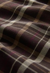 Plaid fabric featuring a dark brown base with light beige and purple lines. The texture appears soft and slightly raised, with a smooth finish.