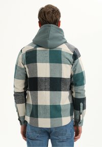 Katoenen flanellen geruite shirt met een capuchon, gekenmerkt door teal, zwart en crème vierkanten, donkere knopen en een zachte, gestructureerde stof.
