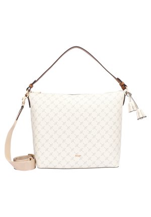 Sac à main couleur crème avec un motif subtil, poignée marron, bandoulière beige amovible et pompons décoratifs sur fond blanc.