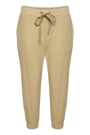 Béžové teplákové kalhoty z měkké látky, s elastickým pasem se šňůrkou na stažení, bočními kapsami a elastickými lemy u kotníků.