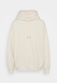 Sudadera color crema fabricada en un material suave, con una capucha grande, cordones y un ajuste holgado. Presenta puños y dobladillo acanalados.