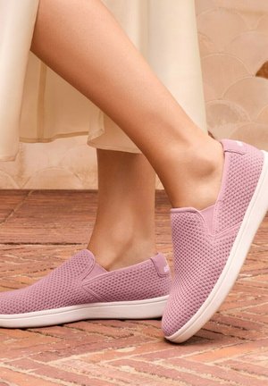 Pink slip-on shoes with a mesh upper and white sole, featuring a textured pattern and minimalistic design. Suitable for casual wear.