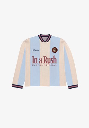 Rugby dlhý rukáv s vertikálnymi krémovými a svetlomodrými pruhmi, námorníckym modrým a ružovým golierom a manžetami, textom "In a Rush International" a kruhovým emblémom.