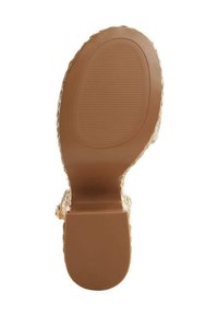 Sandale à talon haut transparent avec une tige transparente et une semelle en caoutchouc marron uni dotée d'un motif antidérapant texturé.