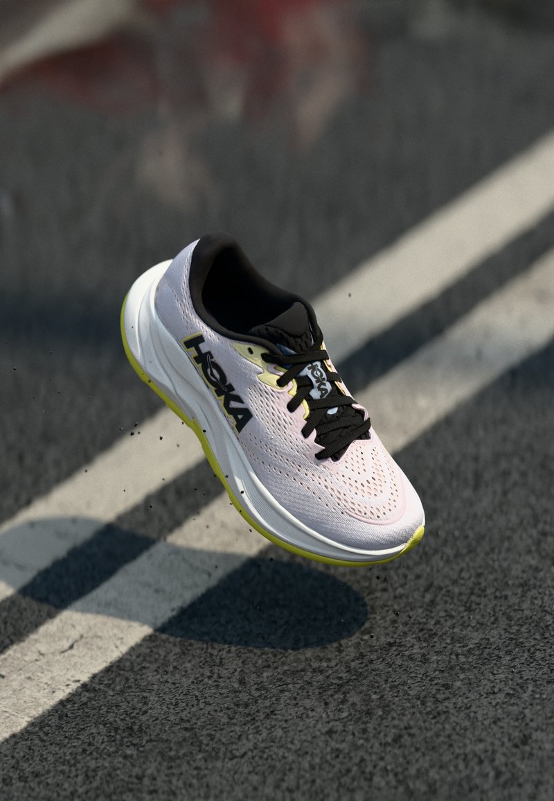 HOKA running shoe featuring a lightweight, breathable pink mesh upper, black accents, and a thick white midsole with yellow detailing.