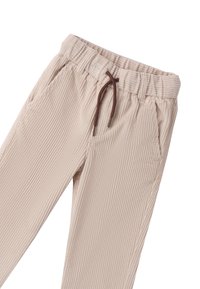 Pantaloni in corduroy beige con vita elastica, cordoncino regolabile marrone e due tasche laterali. Tessuto a coste verticali su tutta la superficie.