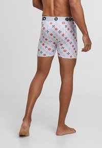 Herrarnas boxershorts med en vit bakgrund och färgglada geometriska mönster. Mjukt tyg, midja till låren, och elastisk midja.