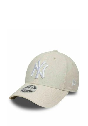 Cappellino da baseball beige dei New York Yankees con visiera curva e logo del team ricamato sul davanti, mostrato su sfondo bianco.