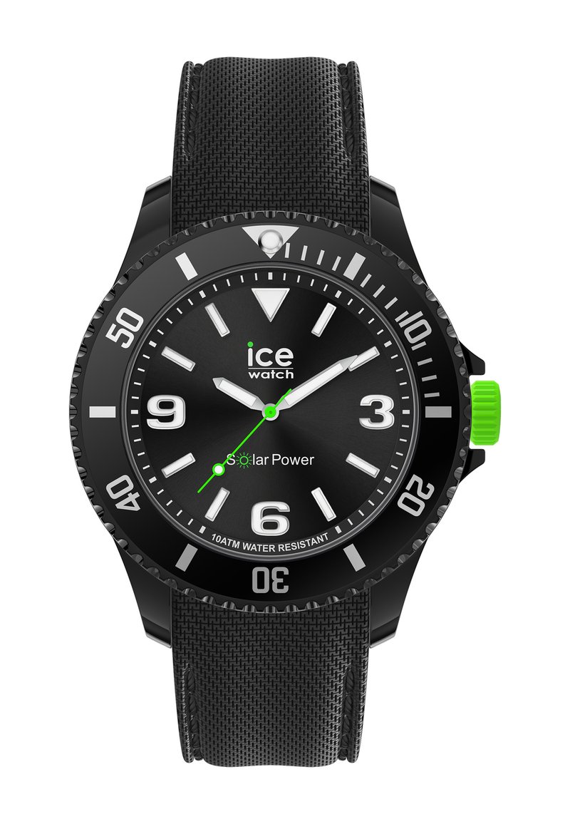 Black solar-powered watch with a textured rubber strap, round black face, white hour markers, three hands, and a green accent on the crown.